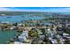 Wonderful aerial view of waterfront homes surrounded by lush landscaping and beautiful blue sea waters at 1214 Bay Shore Blvd, Indian Rocks Beach, FL 33785