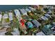 Aerial view of a home surrounded by lush greenery in a waterfront residential neighborhood at 1214 Bay Shore Blvd, Indian Rocks Beach, FL 33785
