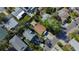 An overhead view of a home nestled amidst trees in a residential neighborhood at 1214 Bay Shore Blvd, Indian Rocks Beach, FL 33785