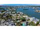 Gorgeous aerial view of waterfront houses in a lively neighborhood surrounded by green landscapes and calm waters at 1214 Bay Shore Blvd, Indian Rocks Beach, FL 33785