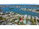 Lovely overhead view of waterfront homes surrounded by lush greenery and calm waters at 1214 Bay Shore Blvd, Indian Rocks Beach, FL 33785