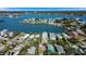 Breathtaking view of waterfront houses surrounded by lush landscaping and serene water at 1214 Bay Shore Blvd, Indian Rocks Beach, FL 33785