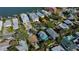 Aerial view of a home surrounded by lush greenery in a waterfront residential neighborhood at 1214 Bay Shore Blvd, Indian Rocks Beach, FL 33785