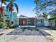 Charming single story home featuring a covered porch with a red front door and gravel landscaping at 1214 Bay Shore Blvd, Indian Rocks Beach, FL 33785