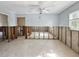 Open concept living room needing completion and repair; natural light from the window brightens the room at 1214 Bay Shore Blvd, Indian Rocks Beach, FL 33785