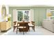 Cozy dining area with wooden table, four chairs, open to living area, sliding glass doors, and modern decor at 12625 Aura Moonlight Ter, Parrish, FL 34219