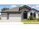 Charming single-Gathering home with a stone facade, three-car garage, and manicured landscaping at 13052 Homestead Ln, Parrish, FL 34219