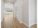 Hallway with light wood floors and glass doors leading to an outdoor space at 13052 Homestead Ln, Parrish, FL 34219