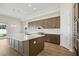 Bright kitchen with large island, stainless appliances, and hardwood floors at 13052 Homestead Ln, Parrish, FL 34219