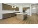 Stylish kitchen featuring an island, stainless steel appliances, and hardwood floors at 13052 Homestead Ln, Parrish, FL 34219