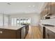 Kitchen featuring a large island with bar seating, stainless steel appliances, and hardwood floors at 13052 Homestead Ln, Parrish, FL 34219