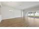 Bright living room with sliding glass doors and hardwood floors at 13052 Homestead Ln, Parrish, FL 34219