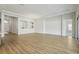Bright, open-plan living room with light wood floors, neutral paint, and modern lighting at 13052 Homestead Ln, Parrish, FL 34219