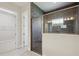 Walk-in shower featuring dark tile, glass doors, and modern fixtures, adding a touch of elegance at 13052 Homestead Ln, Parrish, FL 34219