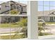 Exterior view of neighboring homes seen through a multi-pane window at 13052 Homestead Ln, Parrish, FL 34219