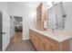 Bathroom featuring wood cabinets with double vanity sinks and a view of the Primary bedroom at 15229 Wind Whisper Dr, Odessa, FL 33556