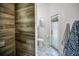 Bathroom with tiled walls, modern toilet, and a doorway to the backyard at 15229 Wind Whisper Dr, Odessa, FL 33556