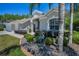 Charming single-story home with well-maintained lawn, landscaping, and palm tree at 15229 Wind Whisper Dr, Odessa, FL 33556
