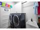 Spacious laundry room with modern washer and dryer, sink and white subway tile backsplash at 15229 Wind Whisper Dr, Odessa, FL 33556