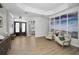 Inviting living room showcasing neutral paint, plenty of natural light, and an ocean-themed art feature at 15229 Wind Whisper Dr, Odessa, FL 33556