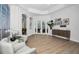 Bright and airy living room featuring wood floors, white walls, and access to the outdoor patio at 15229 Wind Whisper Dr, Odessa, FL 33556