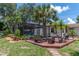 Inviting backyard with a pool area, wooden deck, lush landscaping, and outdoor seating at 1628 12Th Sw St, Largo, FL 33778