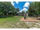 Spacious backyard with screened lanai, deck area, playground and volleyball, perfect for entertaining at 1628 12Th Sw St, Largo, FL 33778
