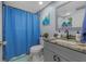 Well-lit bathroom featuring a granite countertop, modern fixtures, and coordinated blue decor at 1628 12Th Sw St, Largo, FL 33778