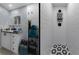 Bathroom with modern vanity and decor, paired with white-tiled shower featuring a black and white mosaic tile floor at 1628 12Th Sw St, Largo, FL 33778