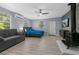Spacious bedroom with a modern bed, sleek furniture, and a cozy fireplace with a mounted television at 1628 12Th Sw St, Largo, FL 33778