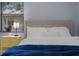 Bedroom featuring a comfortable bed with a stylish bedside table and natural light at 1628 12Th Sw St, Largo, FL 33778
