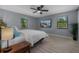 Bright bedroom featuring a comfortable bed, side table with lamp, and ample natural light at 1628 12Th Sw St, Largo, FL 33778