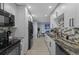 Contemporary kitchen with white cabinetry, granite countertops, and stainless steel appliances, bright open space at 1628 12Th Sw St, Largo, FL 33778