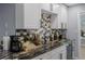 Well-appointed kitchen with granite countertops, tiled backsplash, white cabinets, and stainless steel appliances at 1628 12Th Sw St, Largo, FL 33778