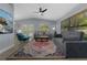 Cozy living room featuring a comfortable sofa, colorful rug, and serene views of the outdoors at 1628 12Th Sw St, Largo, FL 33778