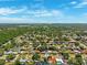 Wide aerial panorama shows a densely populated residential area with tree coverage at 1648 Arbor Dr, Clearwater, FL 33756