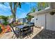 The backyard features a picnic table, a grill, a bench and several trees at 1648 Arbor Dr, Clearwater, FL 33756