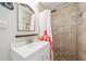 The bathroom features a shower with stone floor, shower curtain and a gold trimmed mirror at 1648 Arbor Dr, Clearwater, FL 33756
