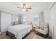 The bedroom features a white rocking chair, a small table, a round mirror, and windows at 1648 Arbor Dr, Clearwater, FL 33756