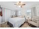 The bedroom features a white rocking chair, a small table, a round mirror, and windows at 1648 Arbor Dr, Clearwater, FL 33756