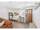 Welcoming foyer boasts a decorative cabinet, wood door, and designer mirror at 1648 Arbor Dr, Clearwater, FL 33756