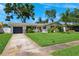 Charming single-Gathering home with a well-kept lawn, mature landscaping, and a welcoming front entrance at 1648 Arbor Dr, Clearwater, FL 33756