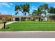 Charming home features a manicured lawn, painted exterior, and lush tropical landscaping at 1648 Arbor Dr, Clearwater, FL 33756