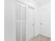 The hallway features laminated floors and white doors with silver door knobs at 1648 Arbor Dr, Clearwater, FL 33756