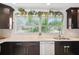 Kitchen area featuring dark cabinets, granite countertops, and stainless steel appliances at 1648 Arbor Dr, Clearwater, FL 33756