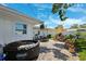Cozy backyard patio with a hot tub, outdoor seating, and lush garden views at 1648 Arbor Dr, Clearwater, FL 33756
