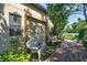 This backyard patio features comfortable seating on a wooden deck, overlooking lush, mature landscaping at 1704 Via Palermo St, Plant City, FL 33566