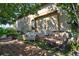 This backyard patio features comfortable seating on a wooden deck, overlooking lush, mature landscaping at 1704 Via Palermo St, Plant City, FL 33566