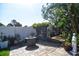 The backyard features a stone fire pit, statues, lush tropical landscaping, and a serene outdoor ambiance at 1704 Via Palermo St, Plant City, FL 33566