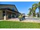 The backyard has a pristine pool, patio with outdoor kitchen and mature landscaping, creating a private oasis at 1704 Via Palermo St, Plant City, FL 33566